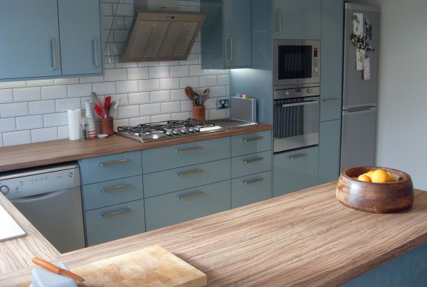 light blue kitchen with natural wood worktop