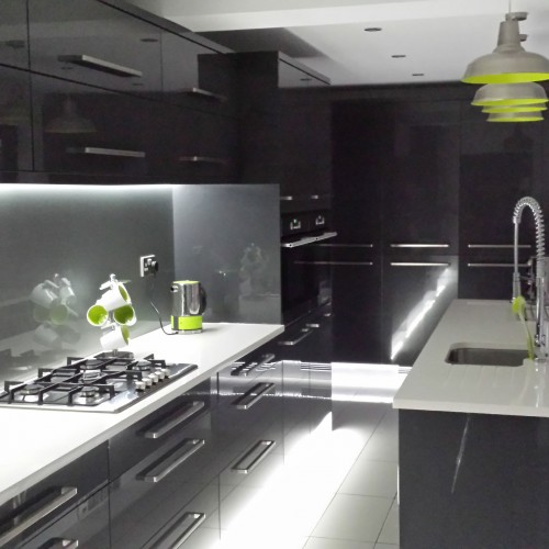 black glossy kitchen with white worktop