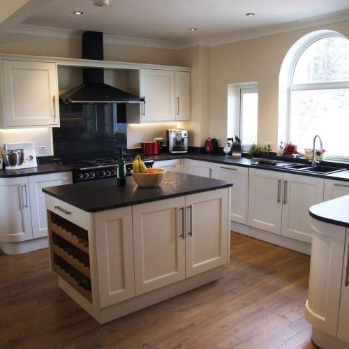 Painted porcelain kitchen with black worktops
