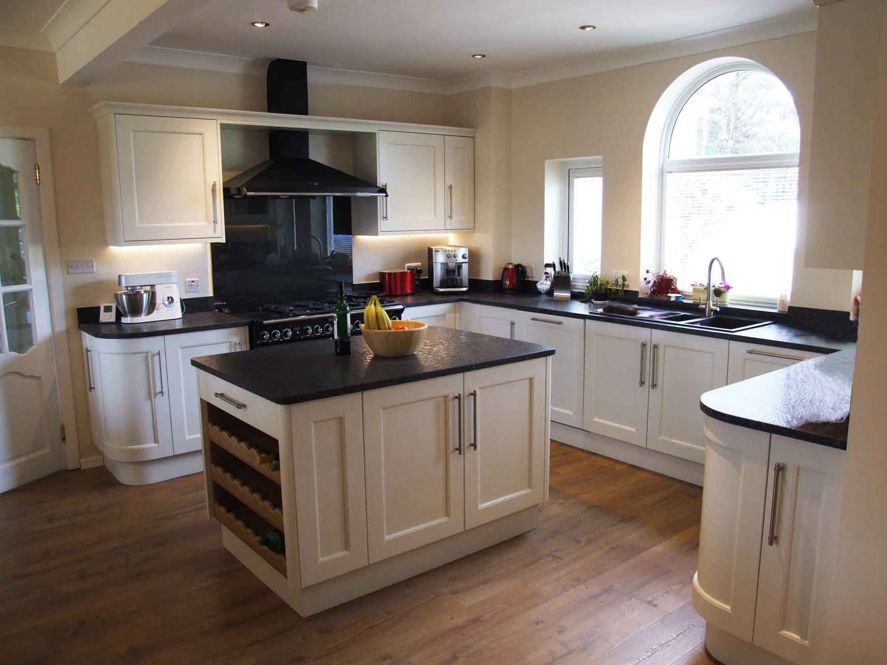 Painted porcelain kitchen with black worktops