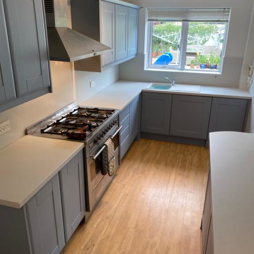 grey kitchen with white worktops